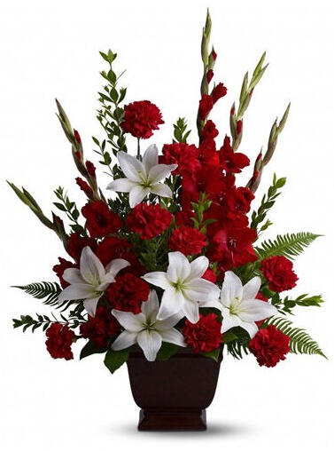Mystique - $79. Classy arrangement containing carnations, lilies and gladioli.