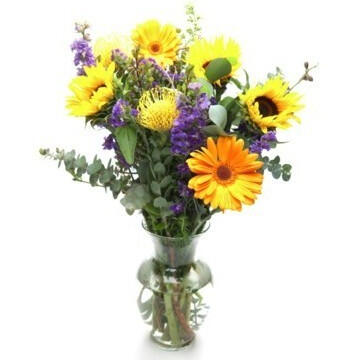 Amber - $42. A bright & cheerful arrangement presented in a glass vase.